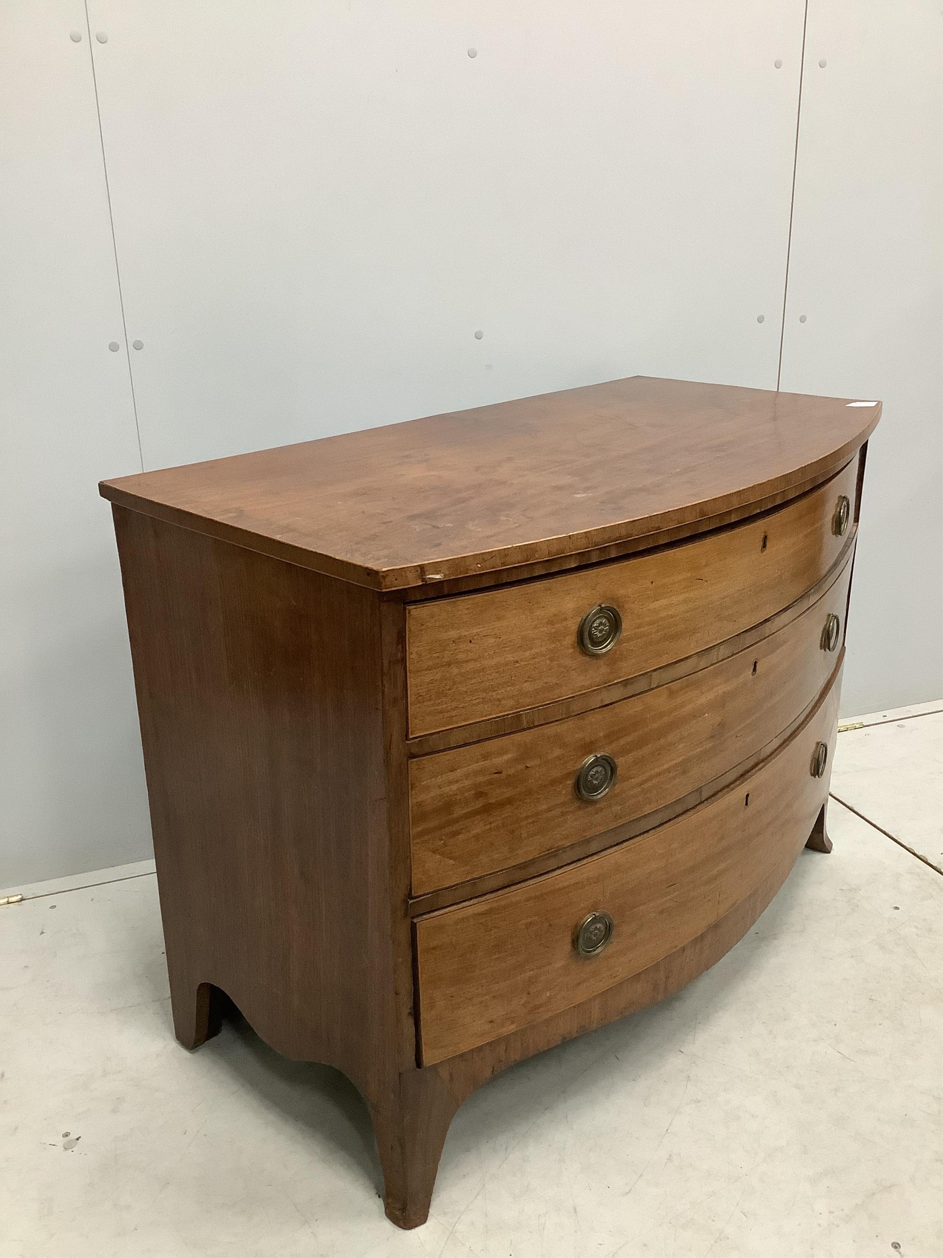 A Regency mahogany bow fronted chest of three drawers, width 109cm, depth 58cm, height 81cm. Condition - poor to fair, top badly marked